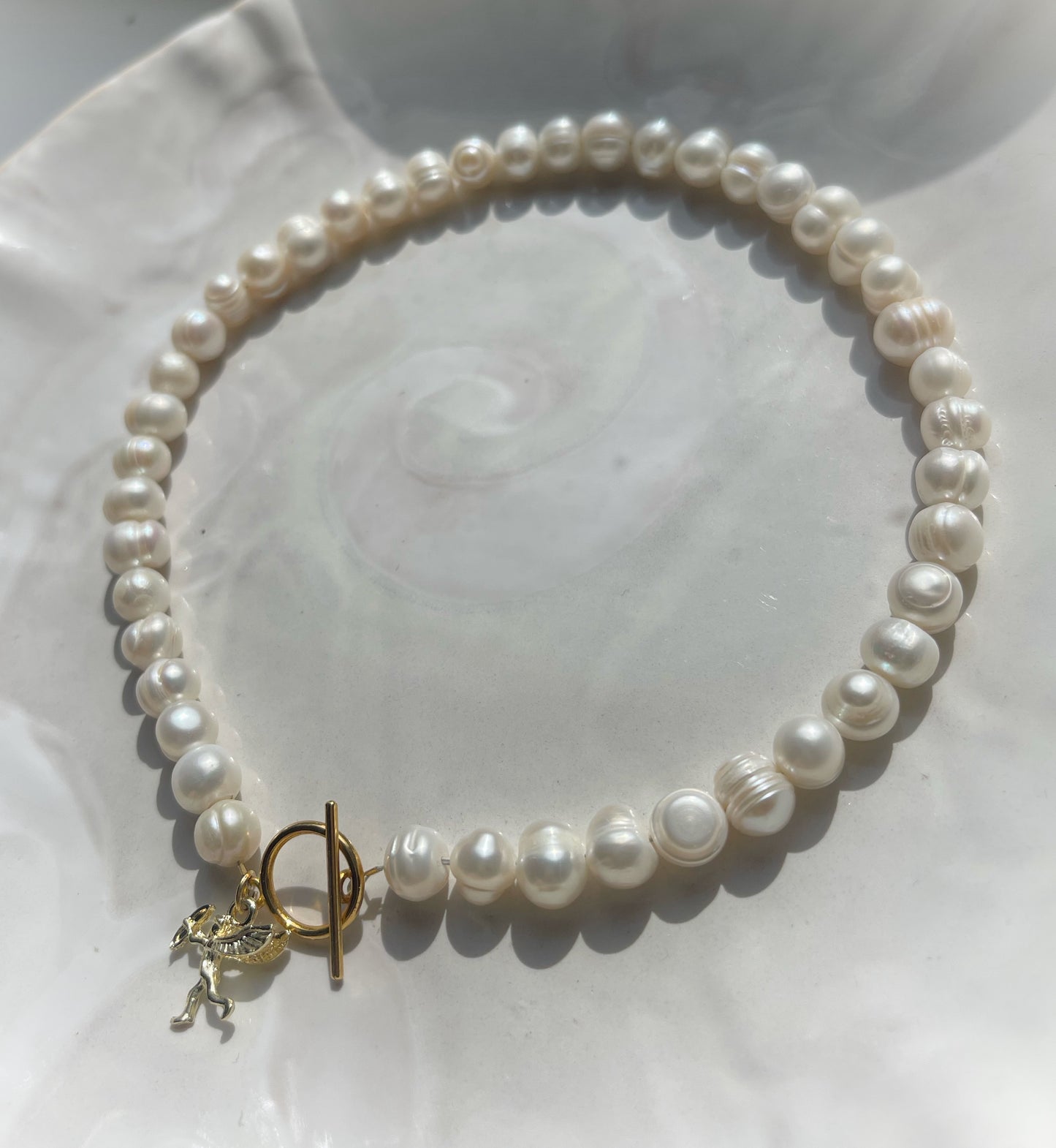 White pearl charm necklace with dainty gold Cupid / cherub charm, classic white pearl jewelry, unique pearl jewelry, summer jewelry
