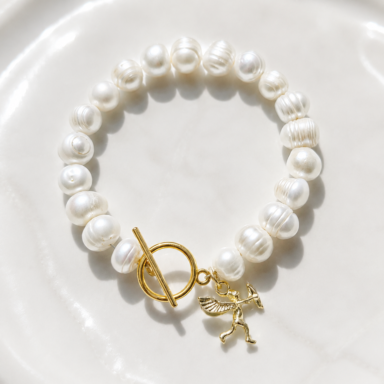 White pearl charm bracelet with dainty gold Cupid / cherub charm, classic white pearl jewelry, unique pearl jewelry, summer jewelry