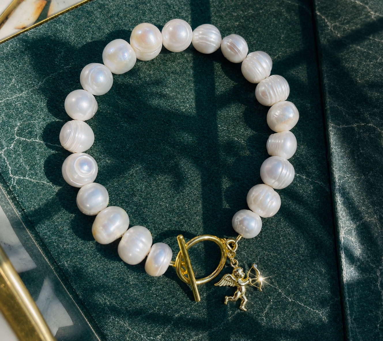 White pearl charm bracelet with dainty gold Cupid / cherub charm, classic white pearl jewelry, unique pearl jewelry, summer jewelry