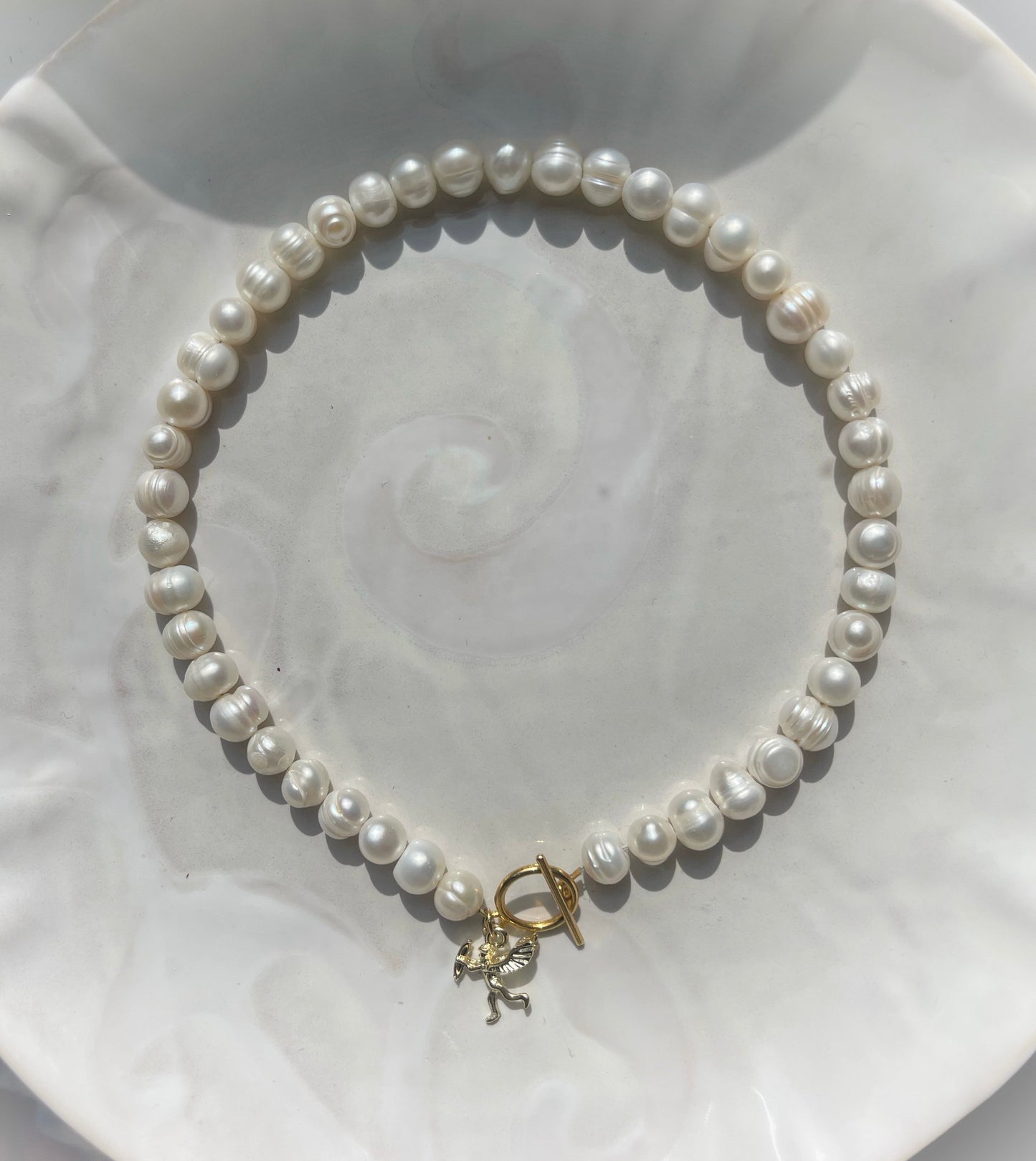 White pearl charm necklace and bracelet matching set with dainty gold Cupid / cherub charm, classic white pearl jewelry, summer jewelry